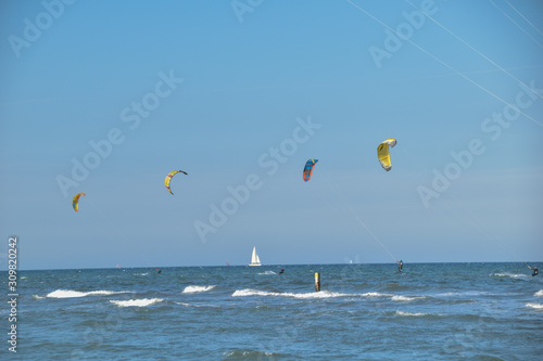 kitesurf and a wind boat on the sea