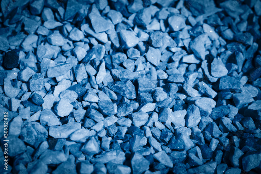 Decorative flowerbed stones background toned in classic blue color of the year 2020 Decorative flowerbed stones background toned in classic blue color of the year 2020