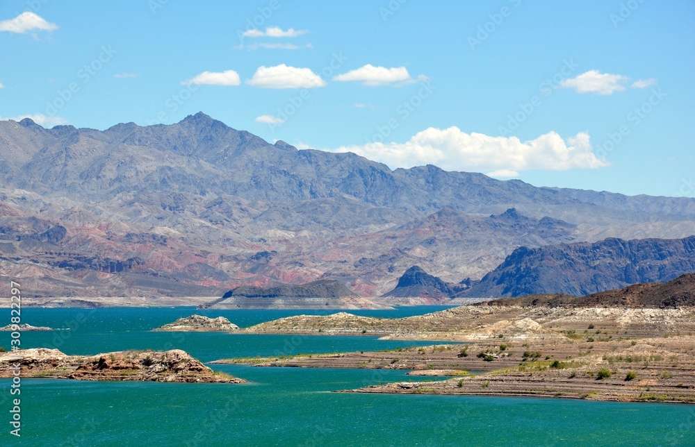 Lake Mead with green water and  layered rocks National Recreation Area near Las Vegas, Nevada