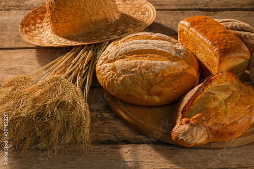 Rural scene with bread and wheat ears. Bread bakery background. Agricultural crop.