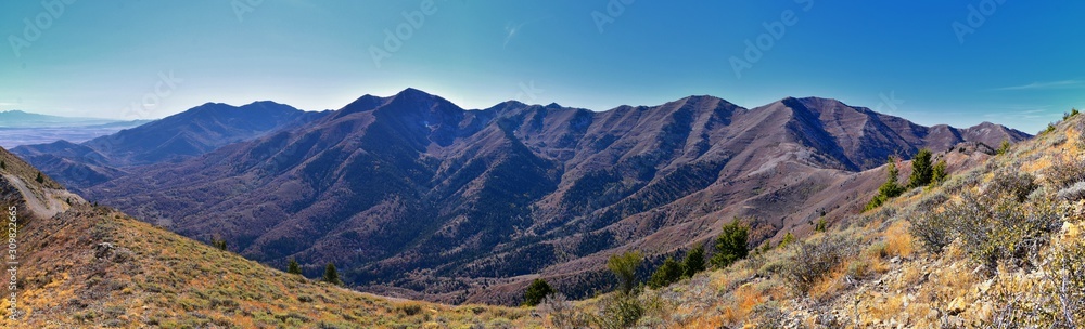 Wasatch Front Rocky Mountain landscapes from Oquirrh range looking at Utah Lake during fall. Panorama views near Provo, Timpanogos, Lone and Twin Peaks. Salt Lake City. United States.