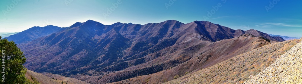 Fototapeta premium Wasatch Front Rocky Mountain landscapes from Oquirrh range looking at Utah Lake during fall. Panorama views near Provo, Timpanogos, Lone and Twin Peaks. Salt Lake City. United States.