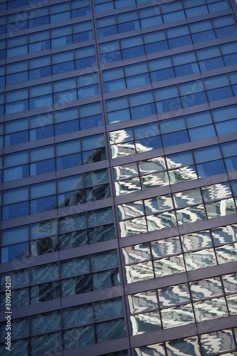 modern office building reflected in windows of building