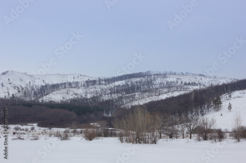 Winter snowy landscape with mountains and trees © YelliJelli