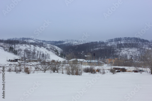 Winter snowy landscape with mountains and trees