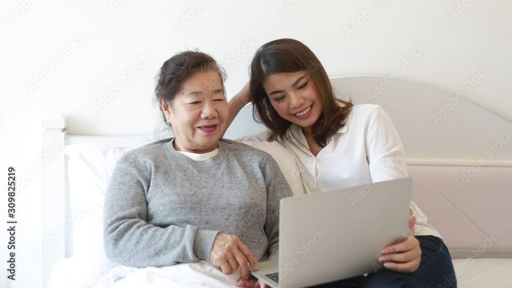 Asian senior woman using laptop computer Asian senior woman using laptop computer