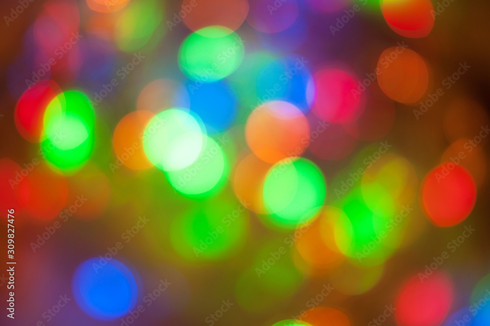 Glowing and festive colored light circles created from in camera and lens bokeh. Christmas fairy lights defocused giving a blurred effect. Background for design. Glowing and festive colored light circles created from in camera and lens bokeh. Christmas fairy lights defocused giving a blurred effect. Background for design.