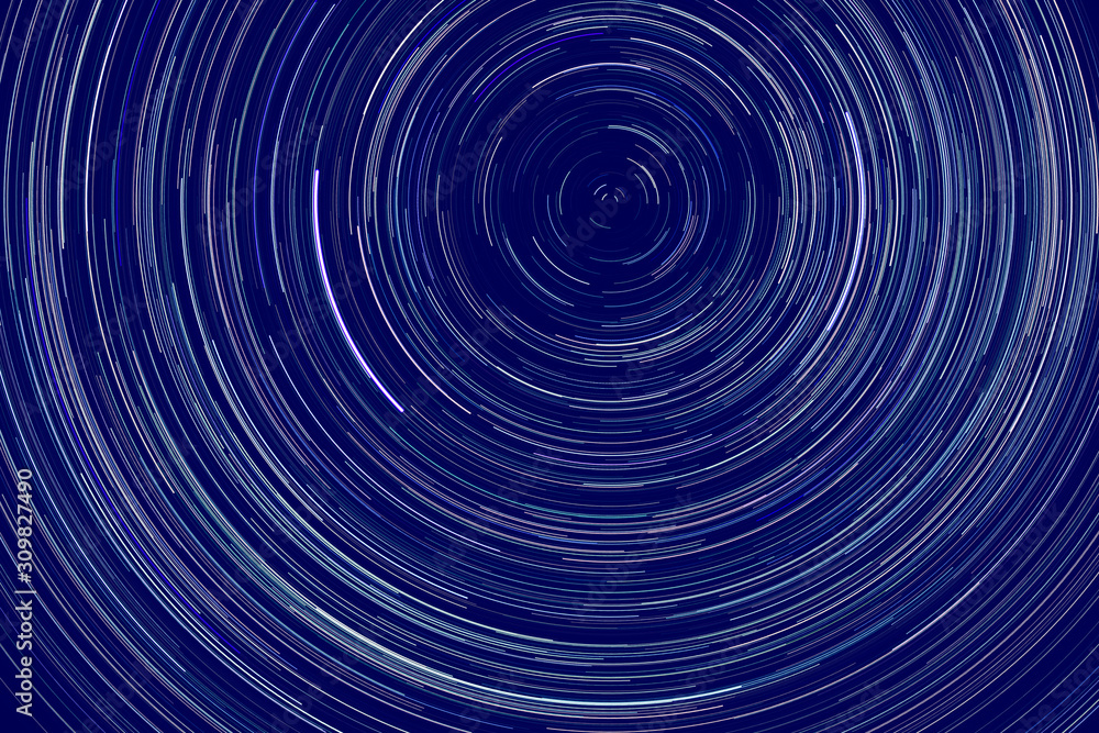 Obraz premium star trails - light streaks of stars around Polaris in the night sky due to Earth's rotation