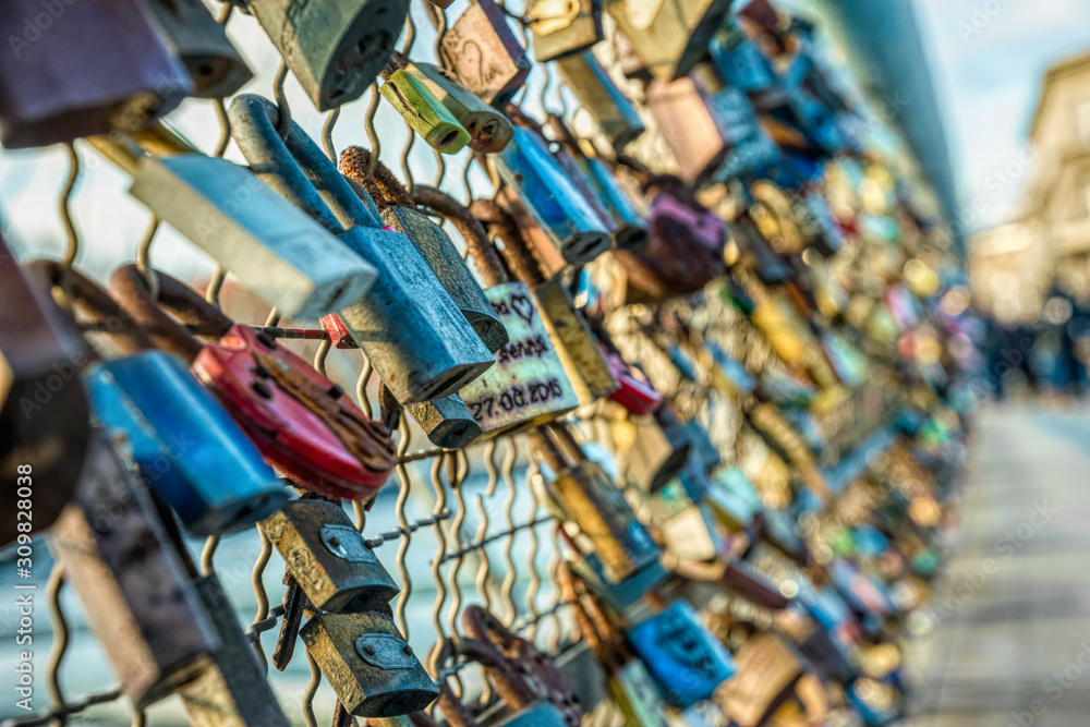 Naklejka premium Love and fidelity. Padlocks on a suspension pedestrian bridge in Krakow, Poland