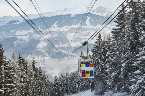Skiing cabin lift above a valley, connecting the to parts of Paradiski, La Plagne and Les Arcs
