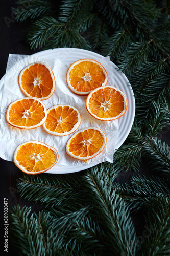 the drying process of sliced oranges on a white plate