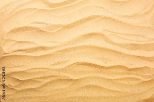 The beach background. Texture yellow sand. Top view with copy space.