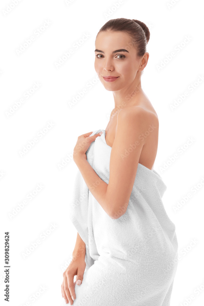 Beautiful young woman wrapped in towel on white background Beautiful young woman wrapped in towel on white background