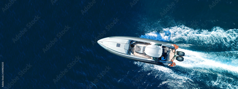 Aerial drone ultra wide top down photo of luxury rigid inflatable speed boat cruising in high speed in Aegean deep blue sea, Greece