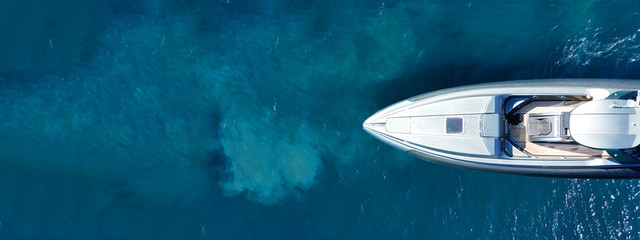 Aerial drone ultra wide top down photo with copy space of luxury rigid inflatable speed boat cruising in high speed in Aegean deep blue sea, Greece