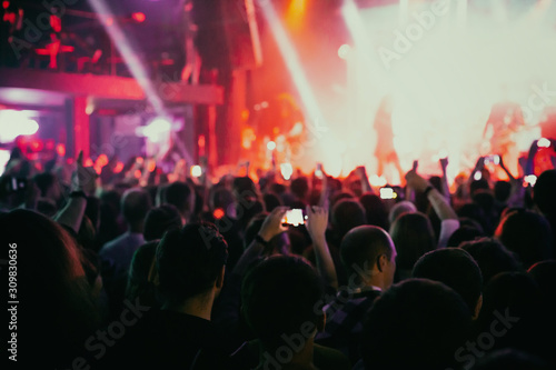 Crowd of spectators having fun at a concert.