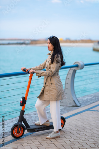 Woman using electric scooter for transportation in a modern city