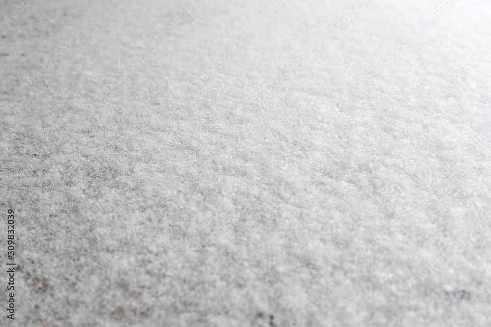 White snow background for designers. White snow closeup snowflakes, perspective. Snow crystals on the earth.