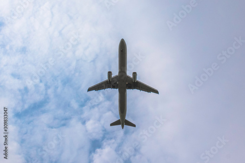 passenger plane against the background of clouds the bottom view