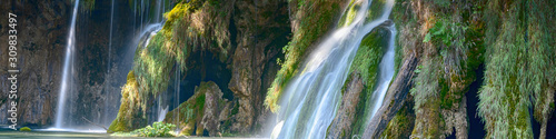 Panoramic waterfall in the forest. Exotic waterfall and lake landscape of Plitvice Lakes National Park  UNESCO natural world heritage and famous travel destin Crystal clear water and natural cascade. 