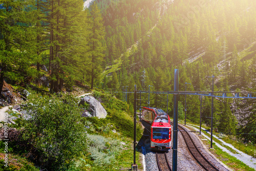 train in the mountains of switzerland photo