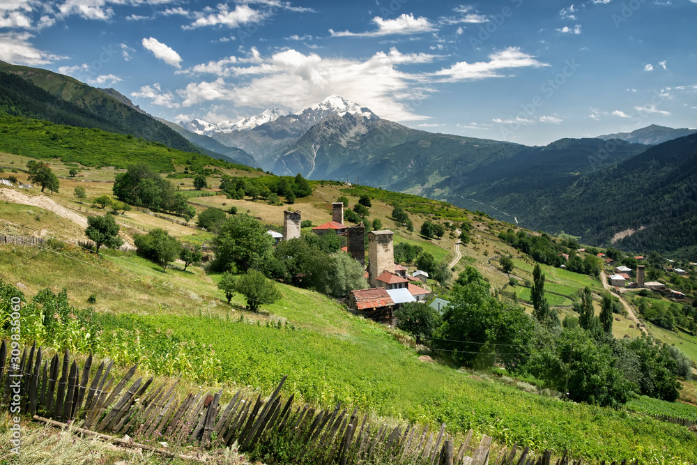 one of the villages of Svaneti on the background of Tetnuldi Mountain, river valley in the Caucasus Mountains, Georgia