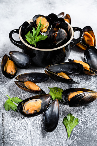 Fresh mussels in wine sauce. The concept of cooking seafood. Gray background. Top view