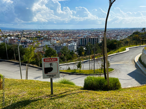 View of the city and the road from the hill. Ahead of the plate: danger. Turkey. Autumn. November 12th 2019.