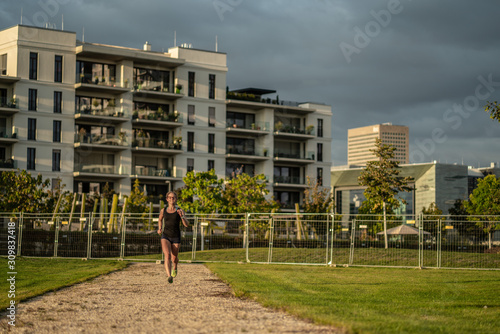 Girl runs through park in new neighborhood photo