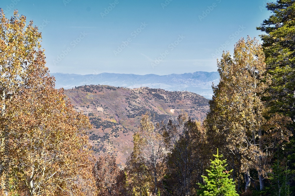 Fototapeta premium Rocky Mountain Wasatch Front peaks, panorama landscape view from Butterfield canyon Oquirrh range by Rio Tinto Bingham Copper Mine, Great Salt Lake Valley in fall. Utah, United States.