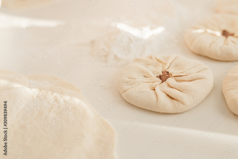 cooking traditional national dish, yeast dough, flour, women hands