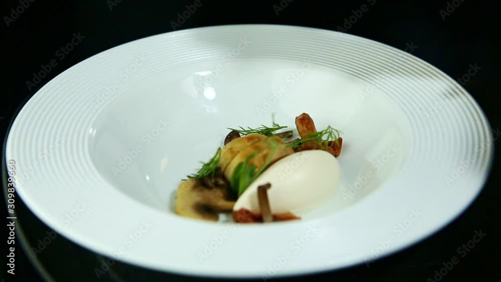 broth pours in white plate with sliced mushrooms and cheese broth pours in white plate with sliced mushrooms and cheese