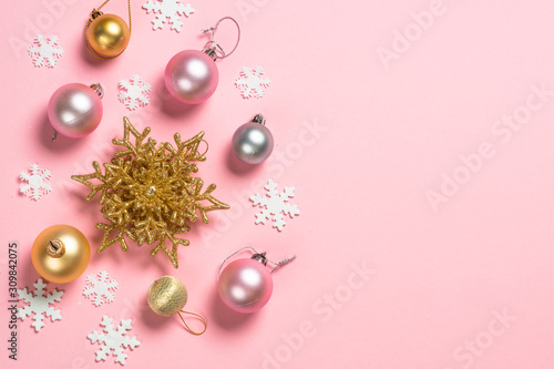Christmas flat lay background on pink with decorations.