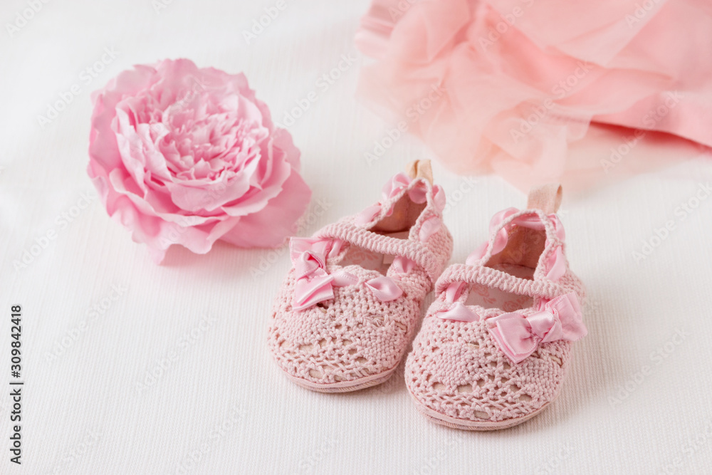 Children's shoes with clothes and a flower on a light background. Children's shoes with clothes and a flower on a light background.