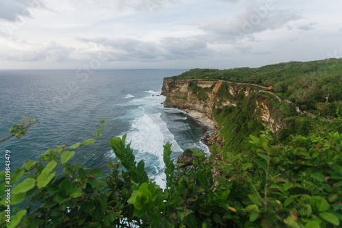 The rocky coast of the island of Bali. Wave, the ocean, evening, clouds.