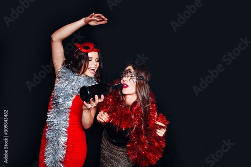 Wallpaper Mural Two women partying in a nightclub and toasting drinks. Happy young people with cocktails at pub. Torontodigital.ca