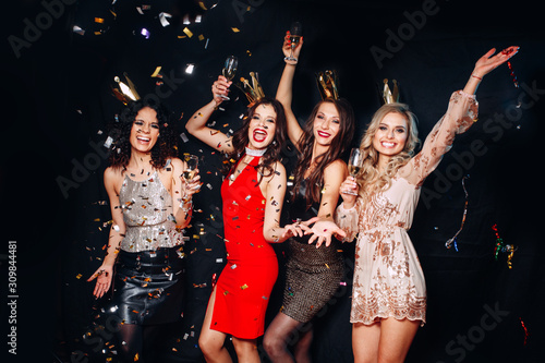 Canvas Print Four young smiling women celebrating birthday party, new year