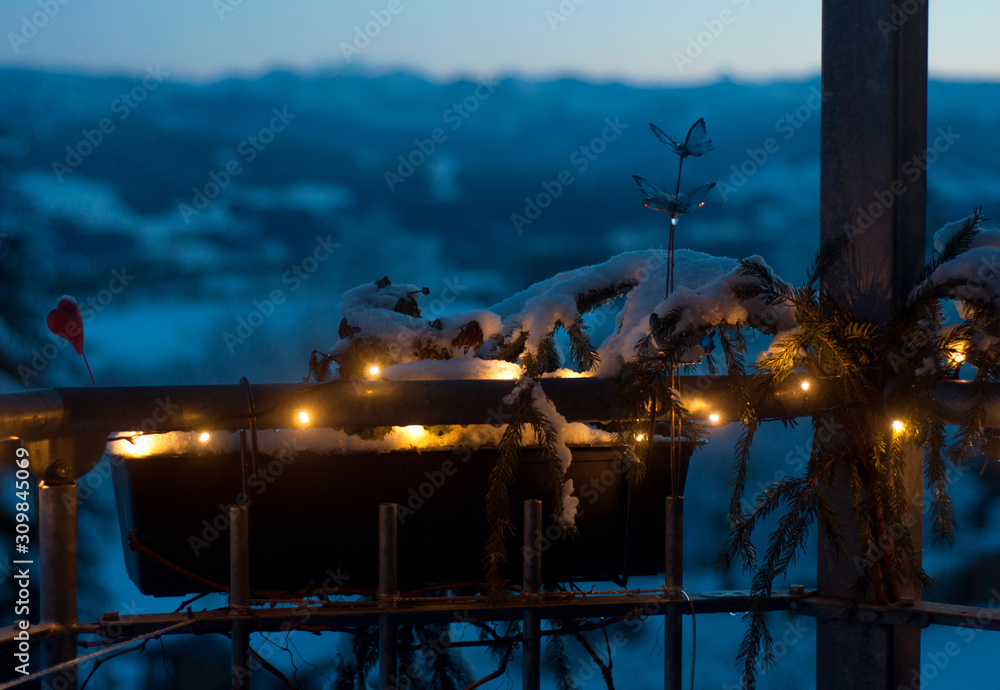View from balcony, decorated with Christmas light. Countryside view. Winter holidays