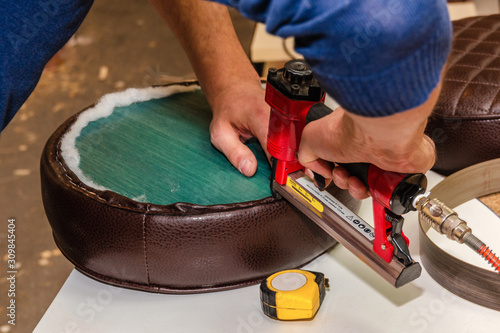 Seat upholstery in a furniture workshop, eco-leather cover
