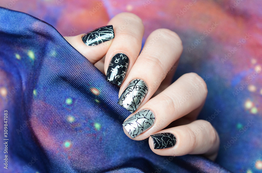 black and gray manicure with a constellation map pattern on a cosmic background black and gray manicure with a constellation map pattern on a cosmic background
