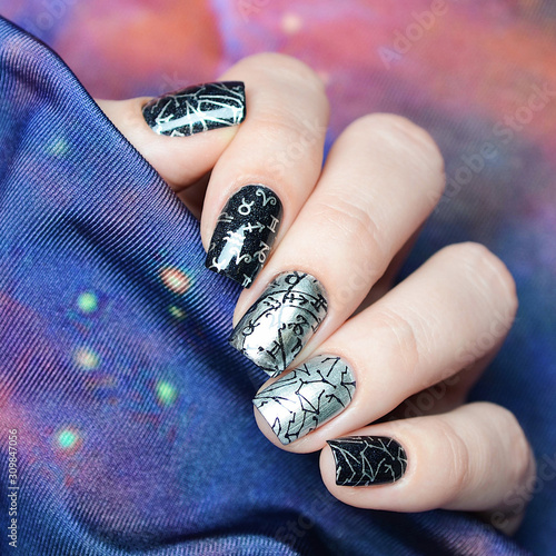 black and gray manicure with a constellation map pattern on a cosmic background