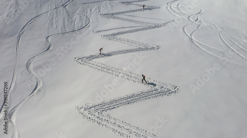 4k aerial photo with ski mountaineers competing during a ski touring race
