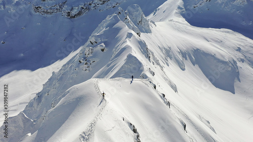 Canvas-taulu 4k aerial photo with ski mountaineers competing during a ski touring race