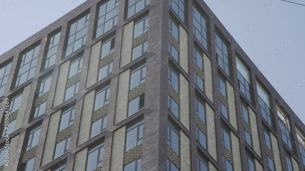 Residential building in New microdistrict. Close up Of An Apartment Blocks. The building features exterior Residential building in New microdistrict. Close up Of An Apartment Blocks. The building features exterior