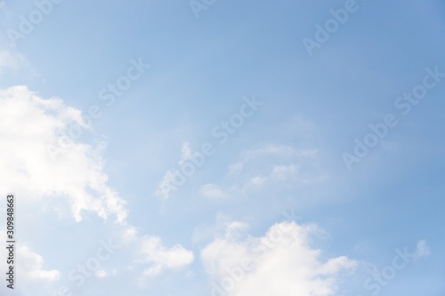 Light pale blue sky with white clouds. Beautiful sky background