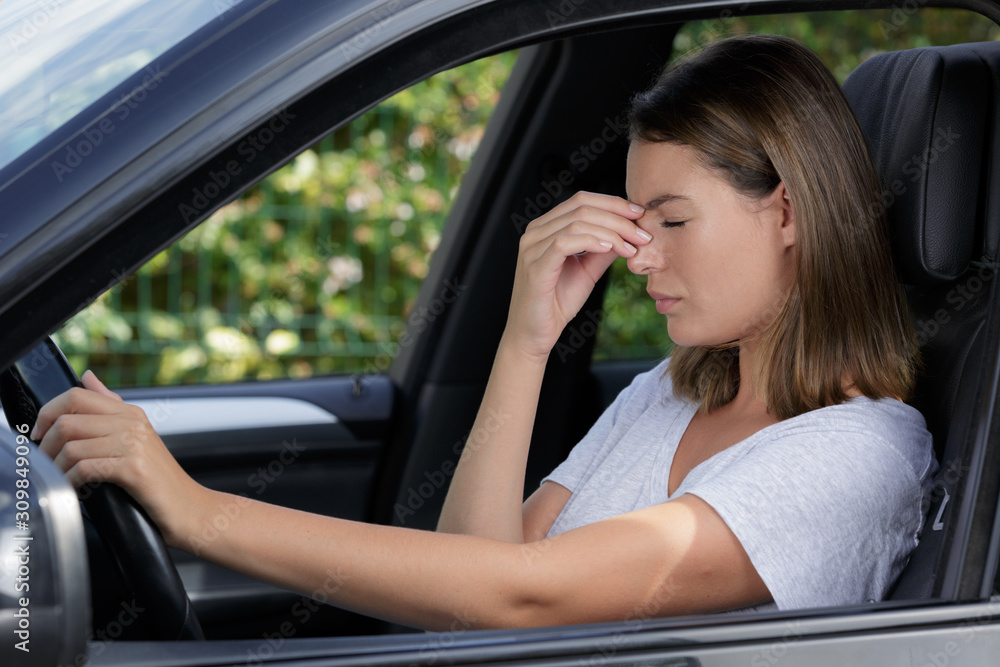 beautiful woman sitting in car suffering from migraines beautiful woman sitting in car suffering from migraines