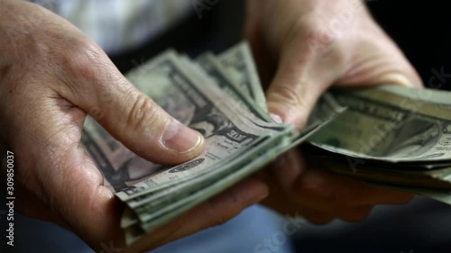 Man counting out dollar bills for an investment. Currency. Salary concept, shopping, buiness.
