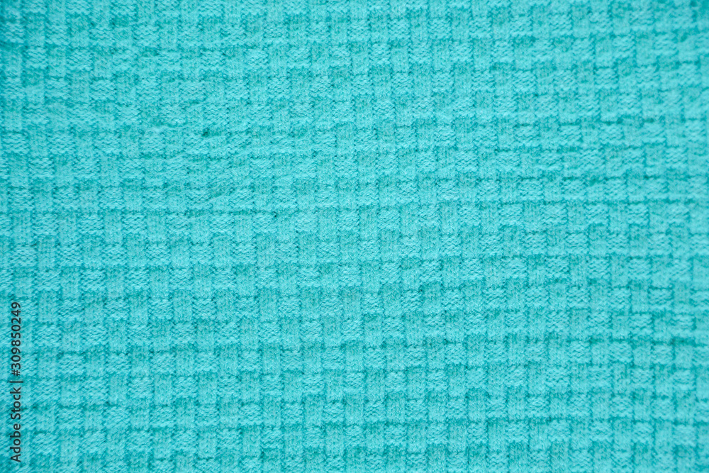 Fototapeta premium turquoise knitted background. Close up gray fabric texture background. wrinkled and shadows, selective focus top view