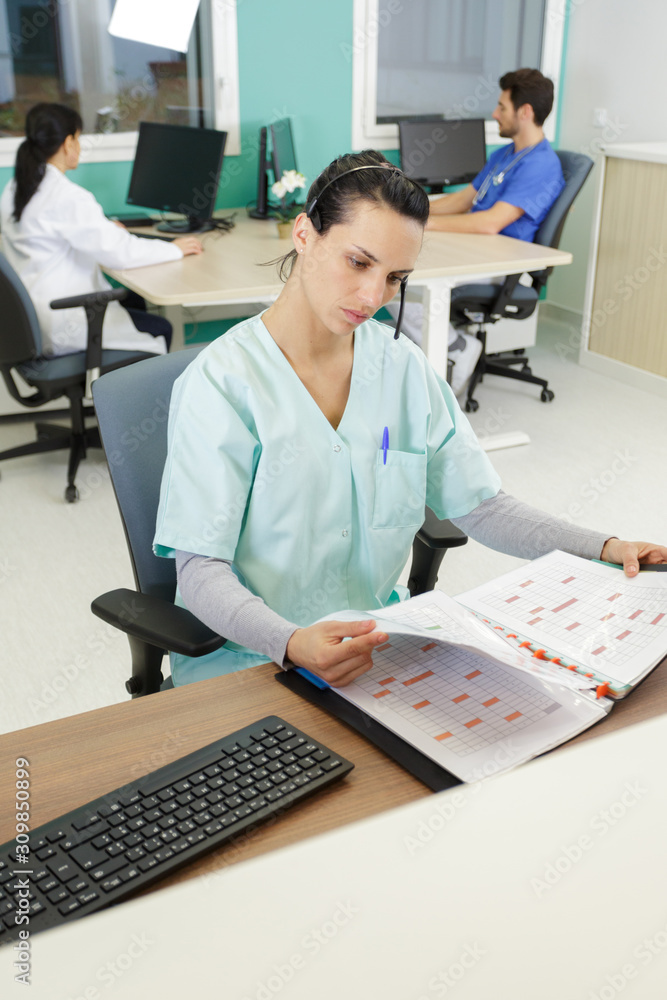 medical secretary going through appointments book medical secretary going through appointments book