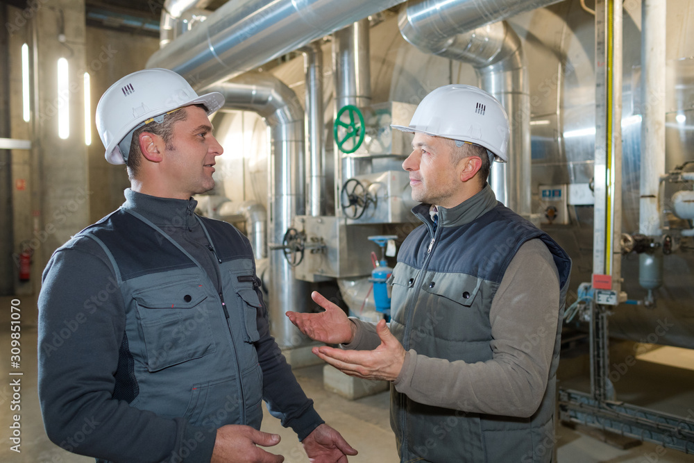 men discussing something in factory men discussing something in factory